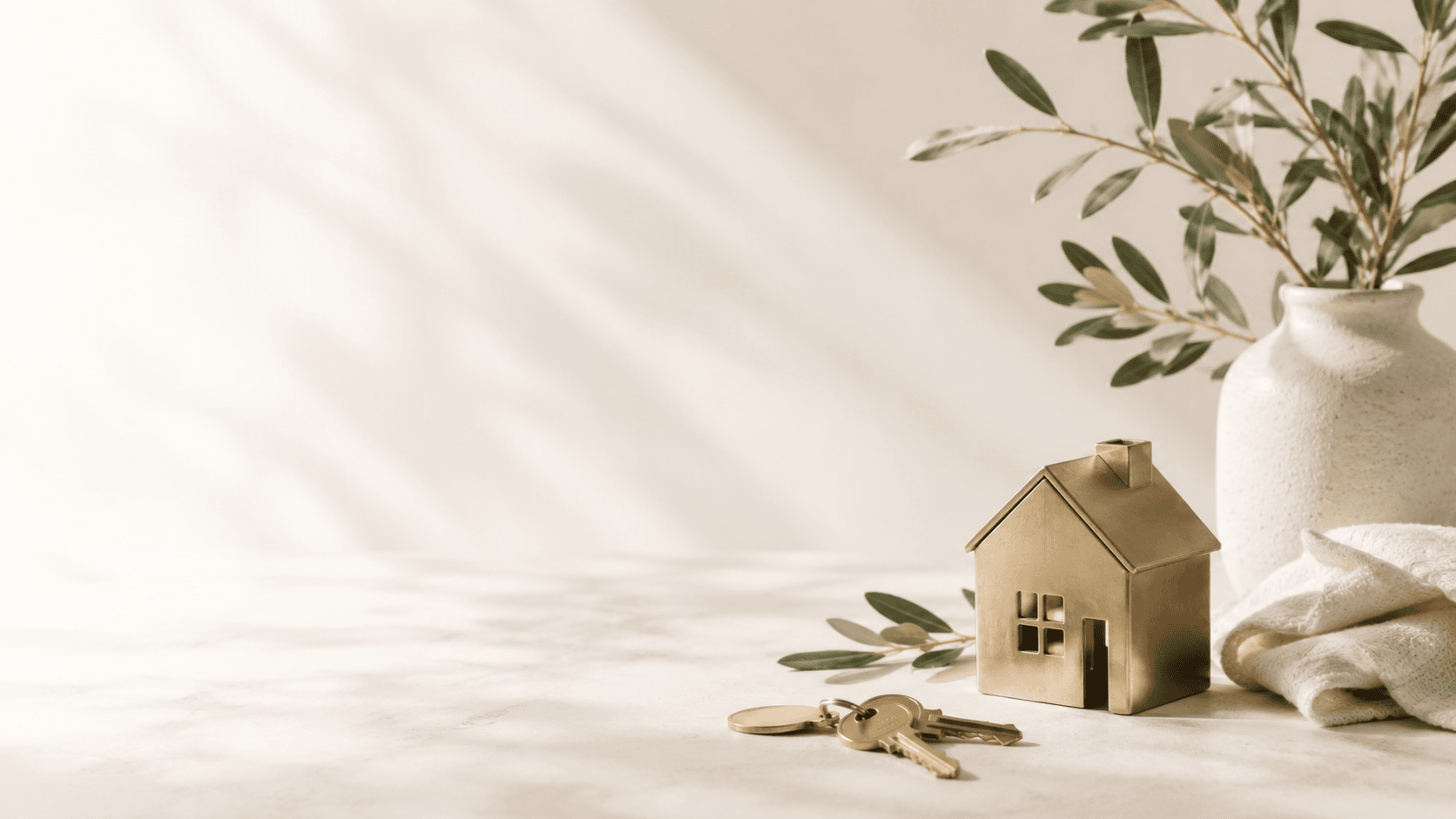Premium property-care products arranged with a gold house ornament